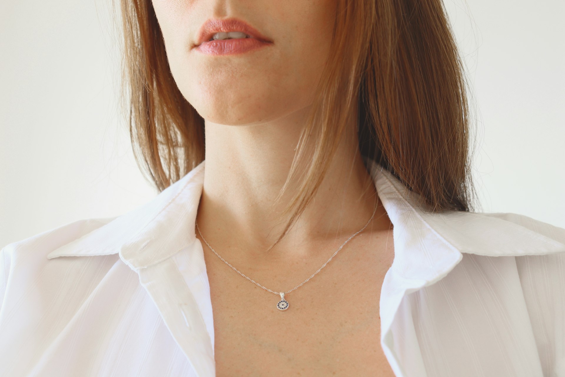 Model wearing a delicate silver pendant necklace
